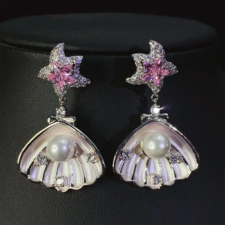 Brincos de conchas cravejadas de diamantes e pérolas