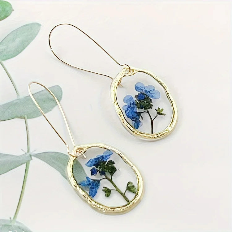Brincos vibrantes de flor miosótis